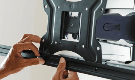 Fitting the TV bracket rail onto the wall plate